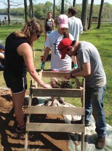 Longwood archaeology students sift for artifacts at their excavation site at Henricus Historical Park.