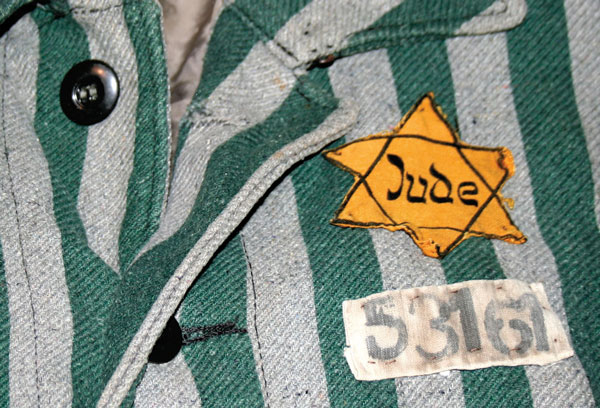 A green and grey striped shirt featuring a yellow star worn by a jewish prisoner