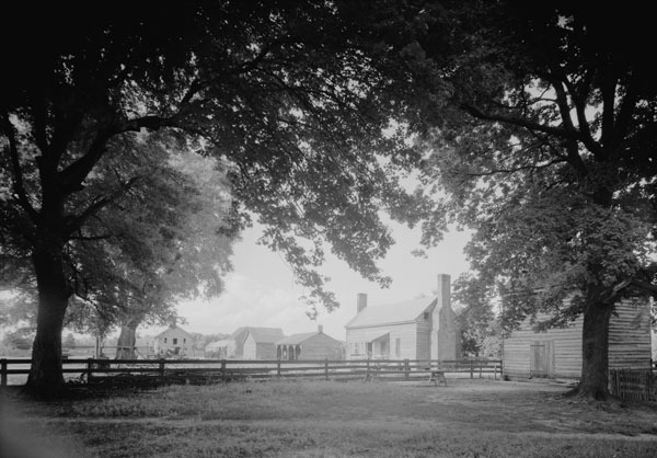 A view of the work yard featuring one of the original slave dwellings at Bacon's Castle in Surry County. Courtesy Library of Congress.